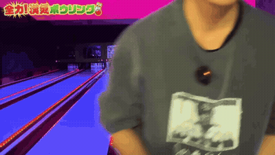 Man In Gray Shirt At Bowling Alley GIF
