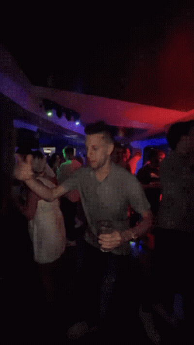 Man In Gray Shirt Dancing In Crowd GIF