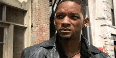 Man In Gray Shirt Making Funny Face At Table GIF