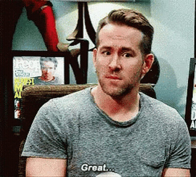Man In Gray Shirt Sitting Saying Great GIF