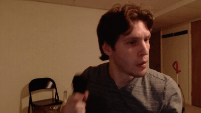 Man In Gray Shirt Standing In Room GIF
