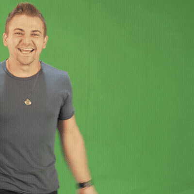 Man In Gray Shirt With Necklace Smiling GIF