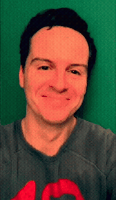 Man In Gray Shirt With Red Heart Smiling GIF