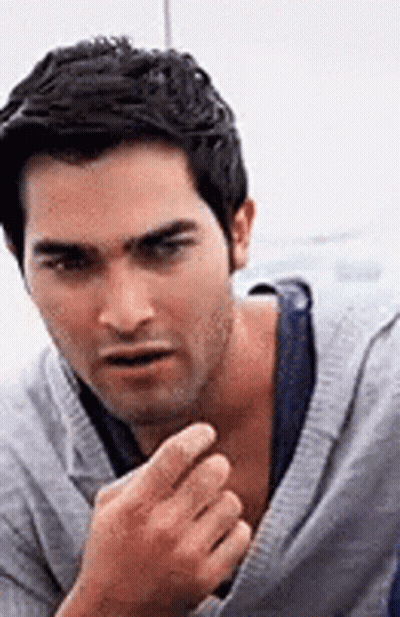Man In Gray Sweater And Blue Tank Top GIF