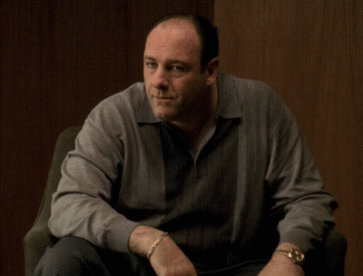 Man In Gray Sweater And Gold Watch Sitting GIF