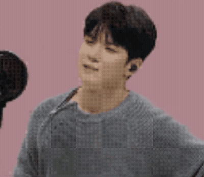 Man In Gray Sweater At Microphone GIF
