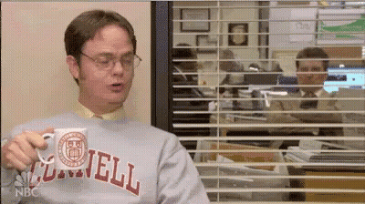 Man In Gray Sweatshirt Holding Mug In Front Of Window GIF