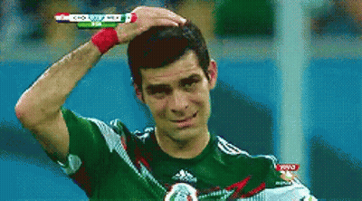 Man In Green Adidas Shirt Holding Head GIF