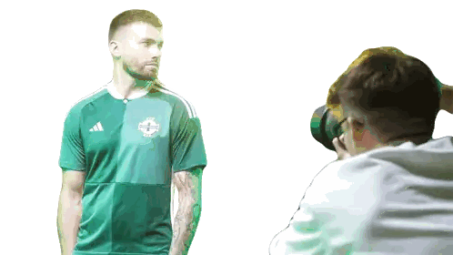 Man In Green Adidas Shirt Photographed By Another Man Sticker