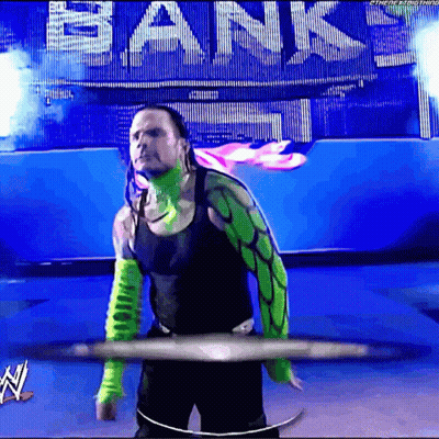 Man In Green And Black Outfit Standing In Front Of Bank Sign GIF