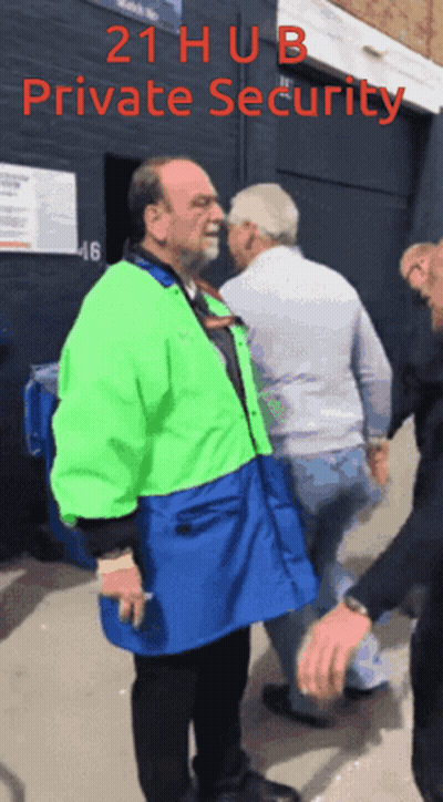 Man In Green And Blue Jacket Escorted By Security Guard GIF