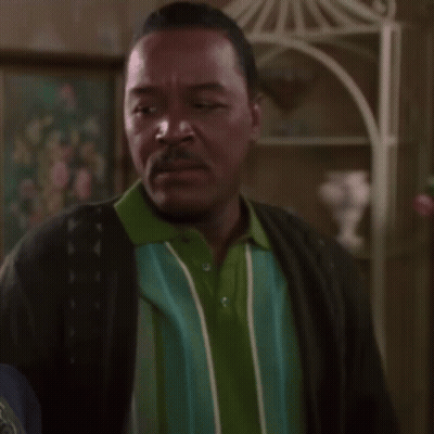 Man In Green And Blue Striped Shirt And Black Cardigan GIF