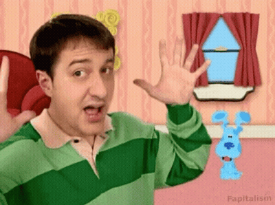 Man In Green And Pink Striped Shirt Waving At Blue Dog GIF
