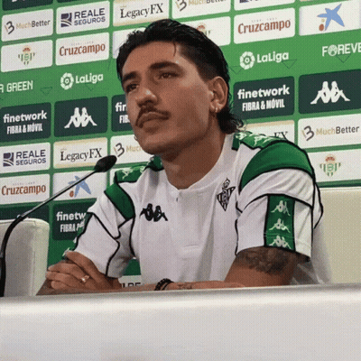 Man In Green And White Shirt In Front Of LaLiga Logo Wall GIF