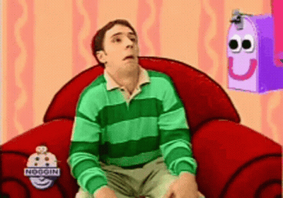 Man In Green And White Striped Shirt Sitting In Red Chair GIF