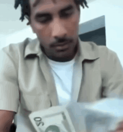 Man In Green And Yellow Football Uniform Holding Gatorade Bottle GIF