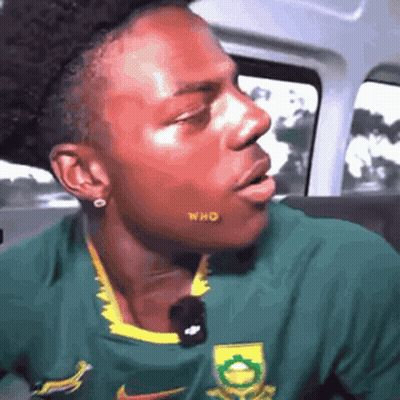 Man In Green And Yellow Nike Shirt In Car GIF
