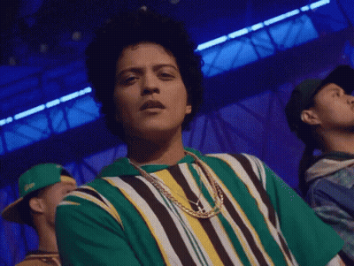 Man In Green And Yellow Striped Shirt And Necklace GIF