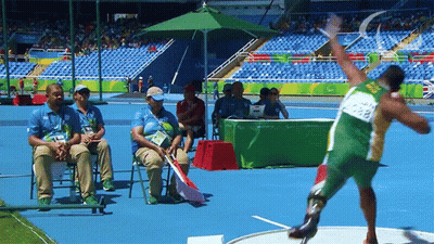 Man In Green And Yellow Uniform Throwing Shot Put GIF