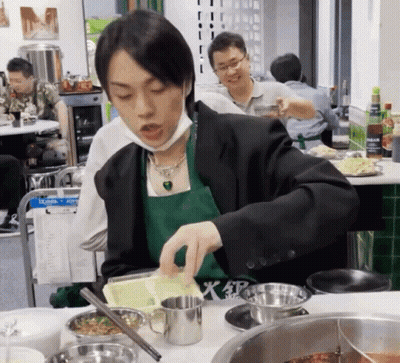 Man In Green Apron And Black Jacket Preparing Food GIF