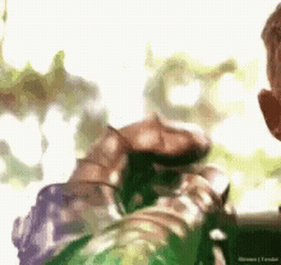 Man In Green Armor Holding Hummingbird GIF