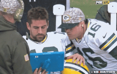 Man In Green Bay Packers Hat Looking At Blue Tablet GIF