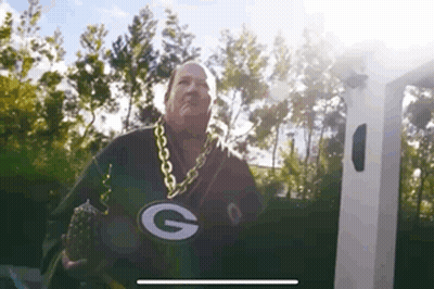 Man In Green Bay Packers Jersey And Gold Chain At Charging Station GIF