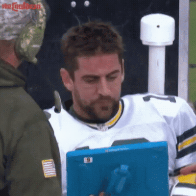 Man In Green Bay Packers Jersey Looking At Tablet GIF