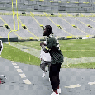 Man In Green Bay Packers Jersey On Stadium Floor GIF