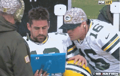 Man In Green Bay Packers Uniform Looking At Tablet GIF
