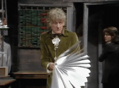 Man In Green Coat Holding Fan GIF