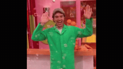 Man In Green Coat Surrounded By Soap Bubbles GIF