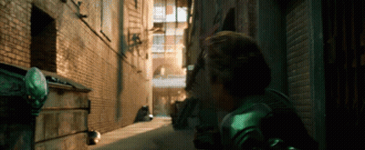 Man In Green Costume Walking Alleyway GIF