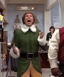 Man In Green Elf Costume Screaming In Room With Other People GIF