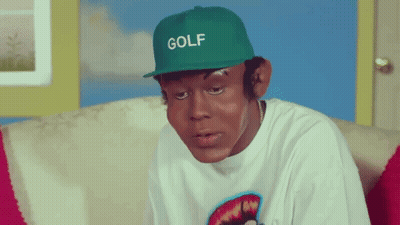 Man In Green Golf Hat Sitting GIF