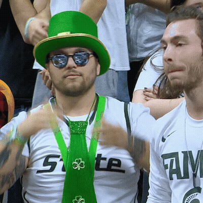 Man in Green Hat and Green Tie Saying State