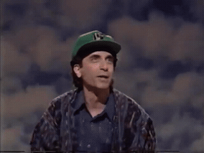Man In Green Hat With Number 15 Next To Woman GIF