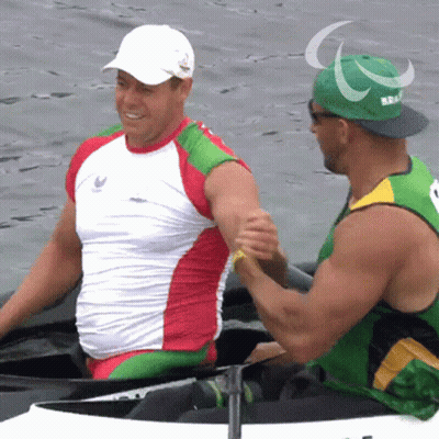 Man In Green Hat With Paralympic Shaking Hands GIF