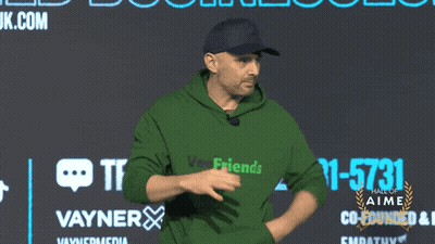 Man In Green Hoodie In Front Of Vayner Wall GIF