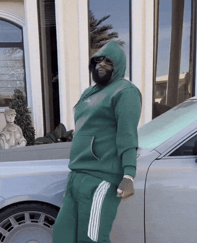 Man In Green Hoodie Leaning Against Car GIF