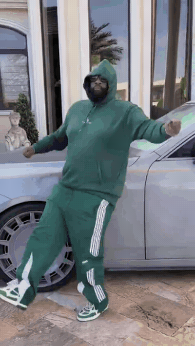 Man In Green Hoodie Standing In Front Of Car GIF