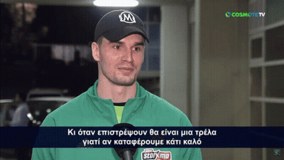 Man In Green Jacket And Black Cap Interviewed By Cosmote TV GIF