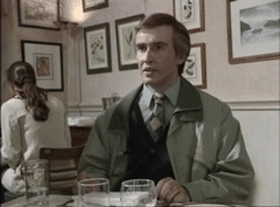 Man In Green Jacket And Tie At Table GIF