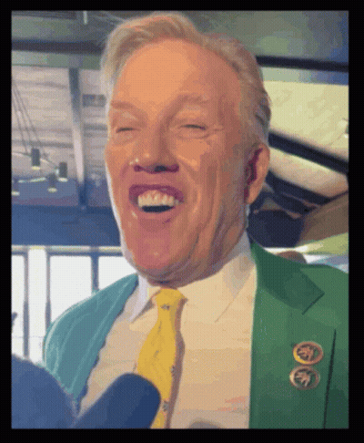 Man In Green Jacket And Yellow Tie Laughing GIF