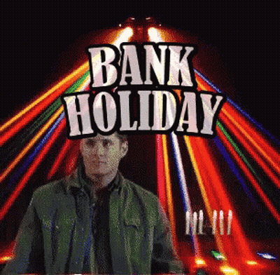 Man In Green Jacket At Bank Holiday Sign GIF