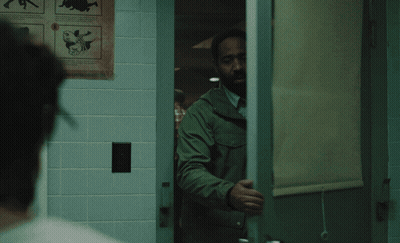Man In Green Jacket In Front Of Window GIF