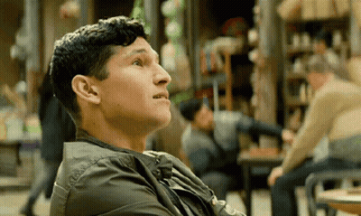Man In Green Jacket Looking Up GIF