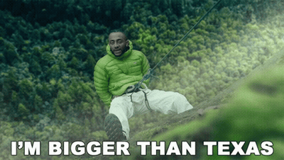 Man In Green Jacket On Cliff Saying I'm Bigger Than Texas GIF