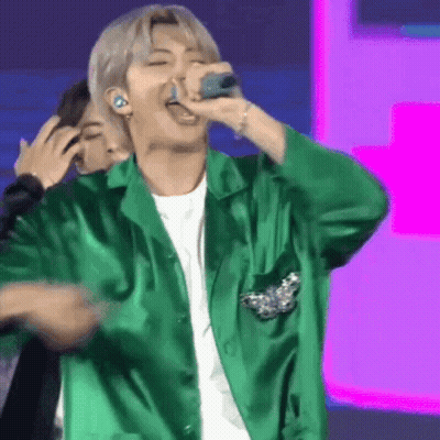 Man In Green Jacket Singing Into Microphone GIF