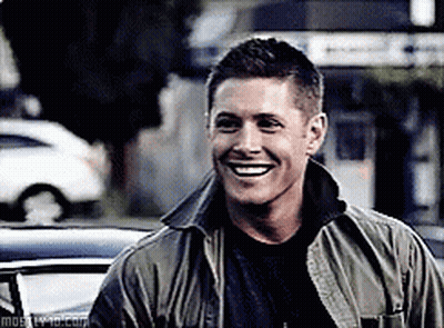Man In Green Jacket Smiling In Front Of Car GIF